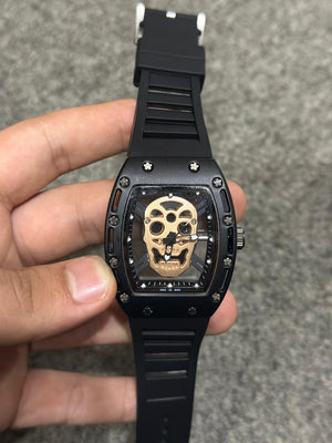 High-end black wristwatch featuring bronze skull motif on dial